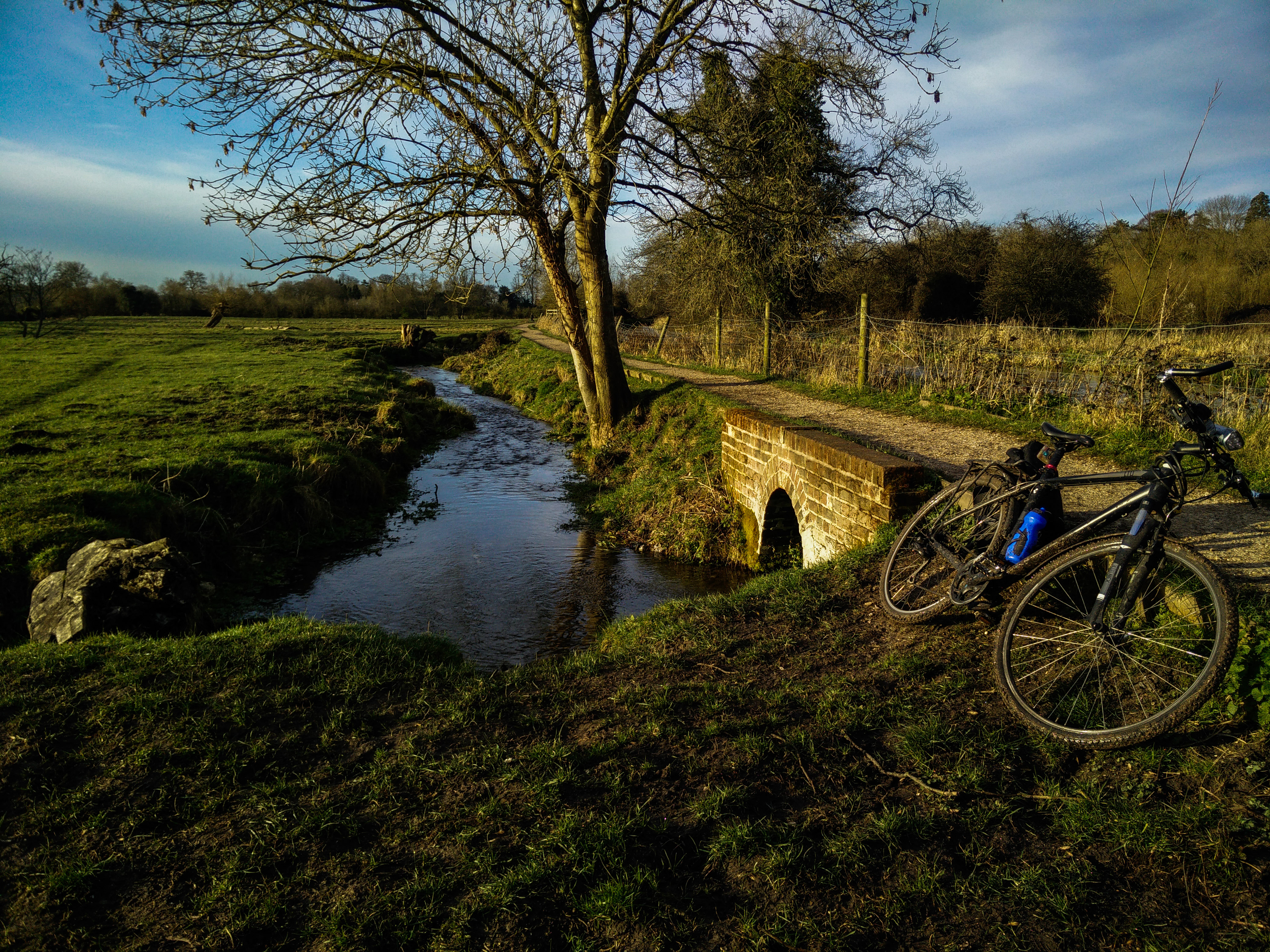 The spot where I stopped to wash my legs; my bike lain on the grass by the stream.