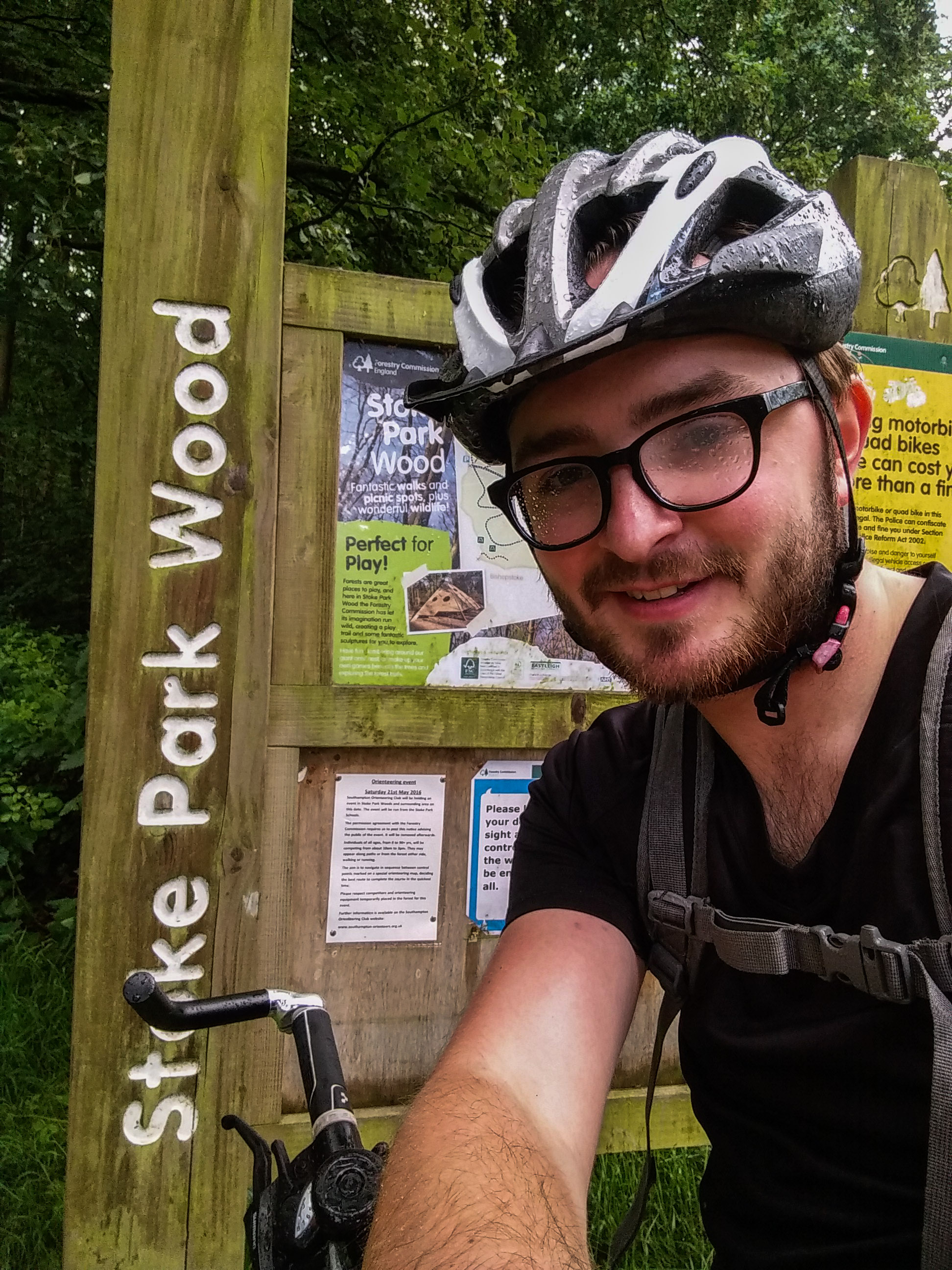 Standing by the Stoke Park Wood sign.